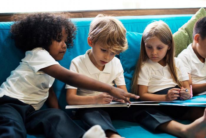 Reception children reading a book